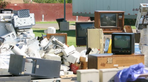 Workers wearing PPE and handling waste during a clearance